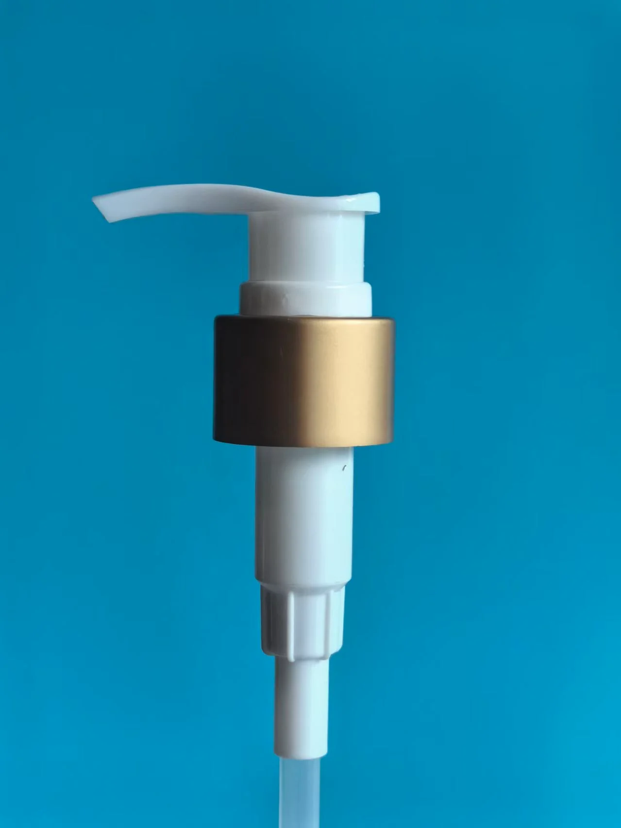 White lotion pump with satin gold-tone collar